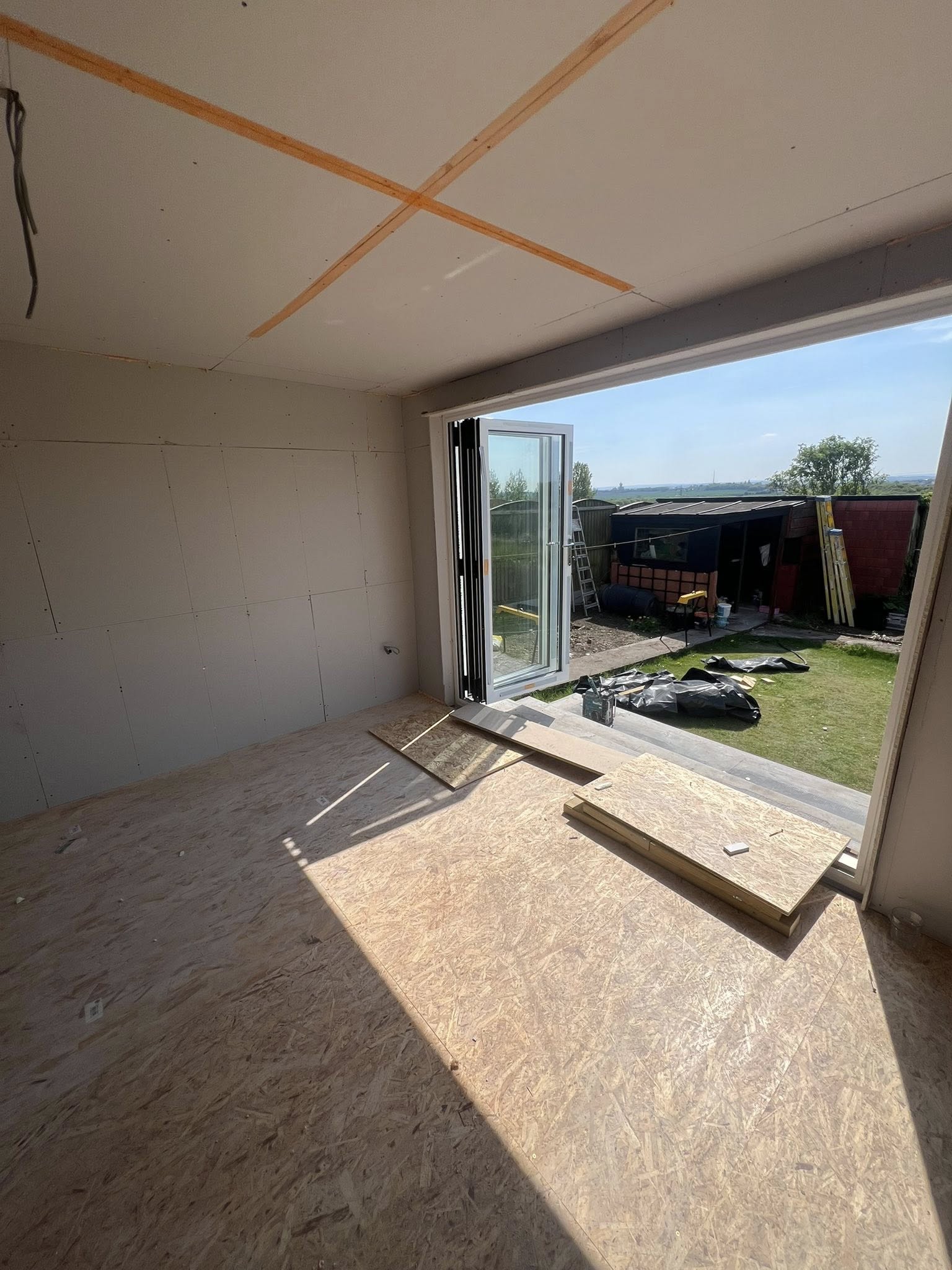 Extension with bi-fold doors and OSB flooring during construction